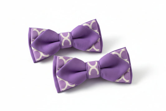 Two purple hair bows with white patterns